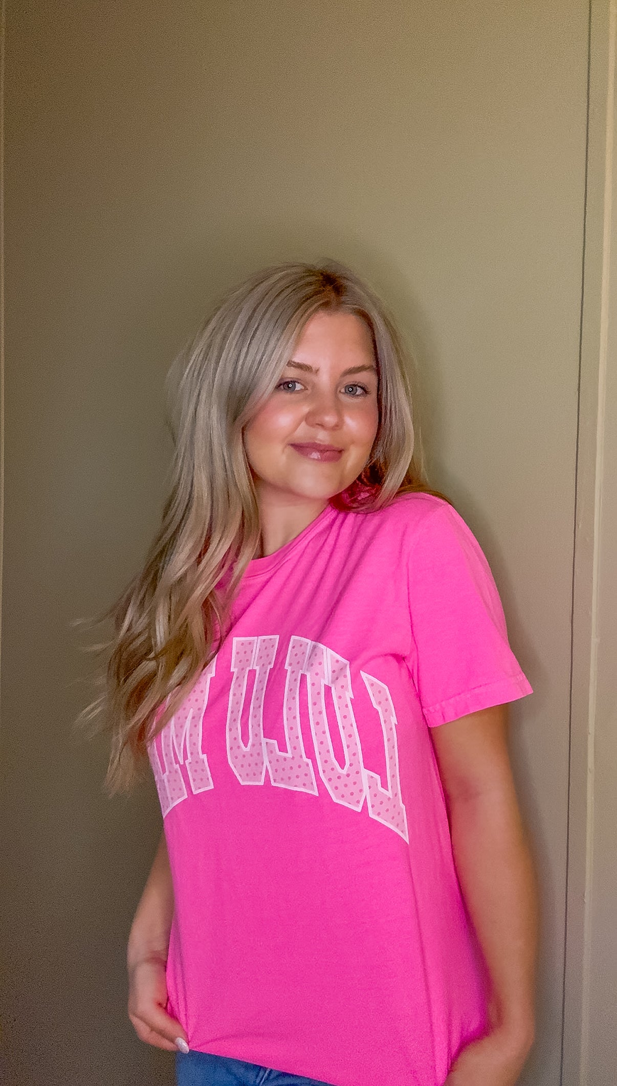Blonde woman modeling neon pink Comfort Colors t-shirt with white polka dot Lulu Mac graphic, casual short sleeve boutique style