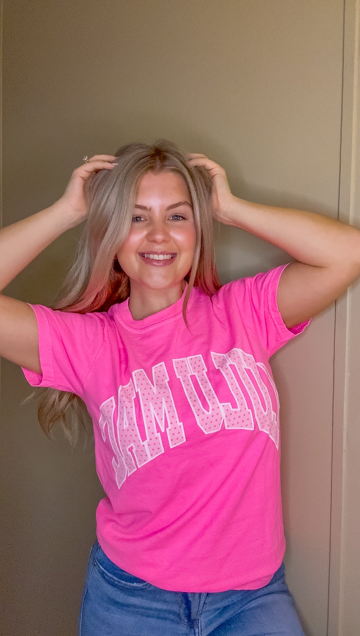 Blonde woman modeling neon pink Comfort Colors t-shirt with white polka dot Lulu Mac graphic, casual short sleeve boutique style