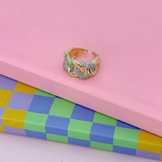 A bold chain-link ring with gold and crystal accents
