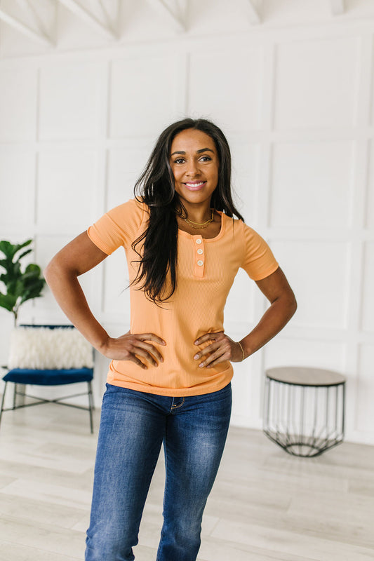 Ribbed Jersey Knit, short sleeve top in light Orange
Decorative Buttons
Scoop Neckline
Slim Fit
95% Polyester, 5% Spandex
True to Size