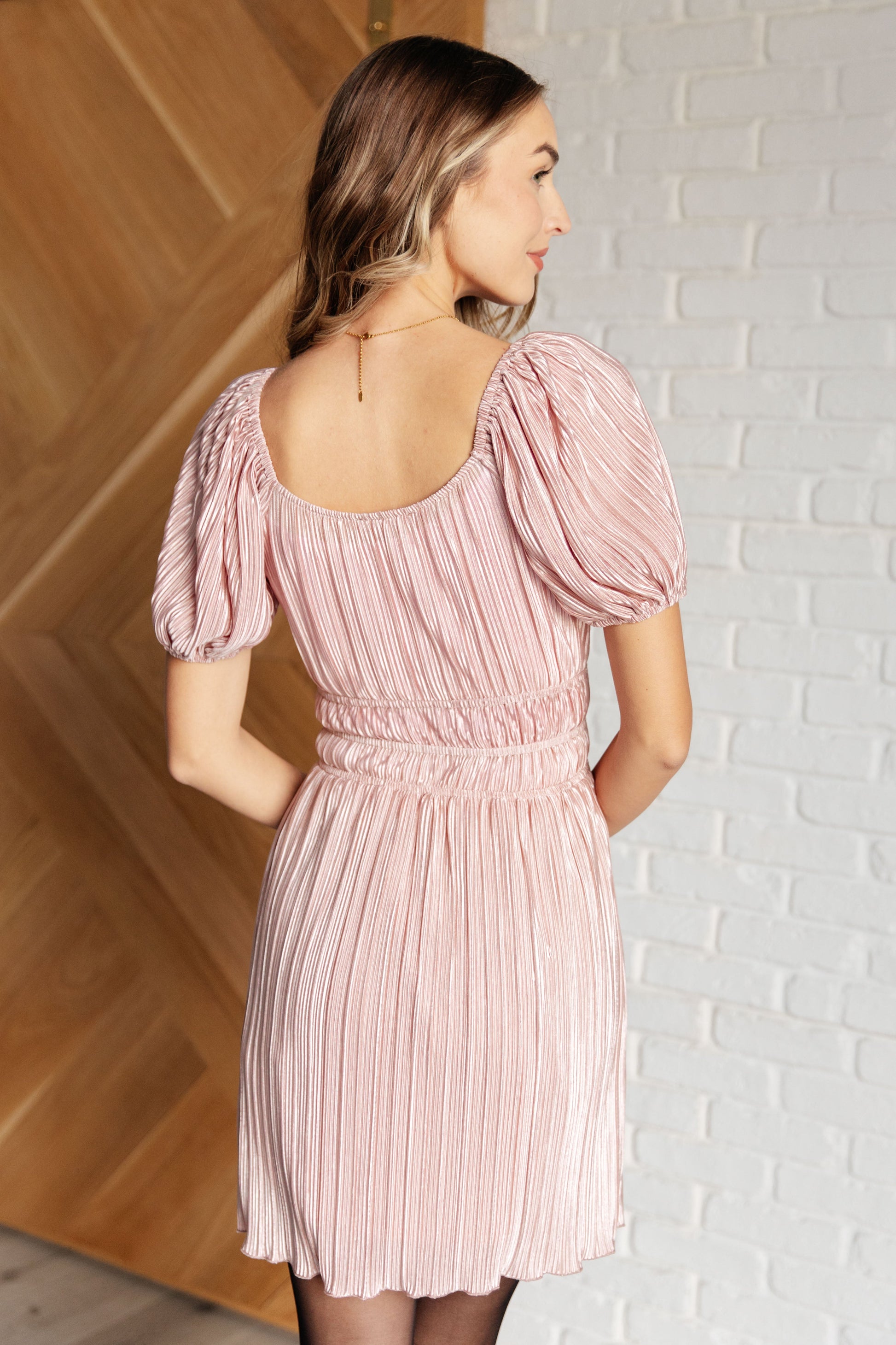 Pink Poly Satin short sleeved dress
Plisse
Cased Elastic Shoulder
Scoop Neck/Off Shoulder
Balloon Sleeve
Cased Elastic Sleeve Cuff
Cased Elastic Waistline
Lined Skirt
Self and Lining: 100% Polyester
True to Size