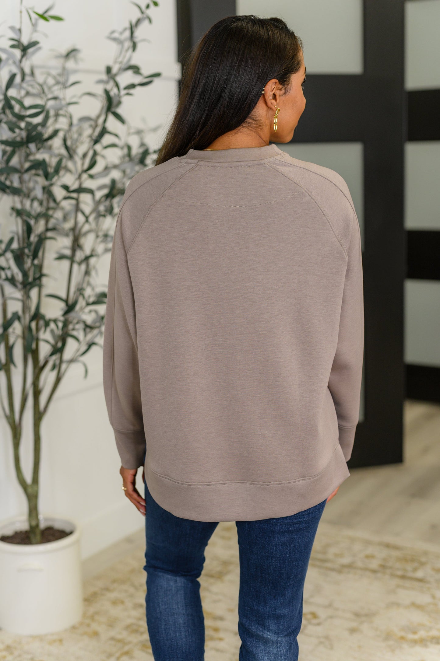 Cocoa relaxed scuba pullover with a round neckline, raglan sleeves, and side slits.