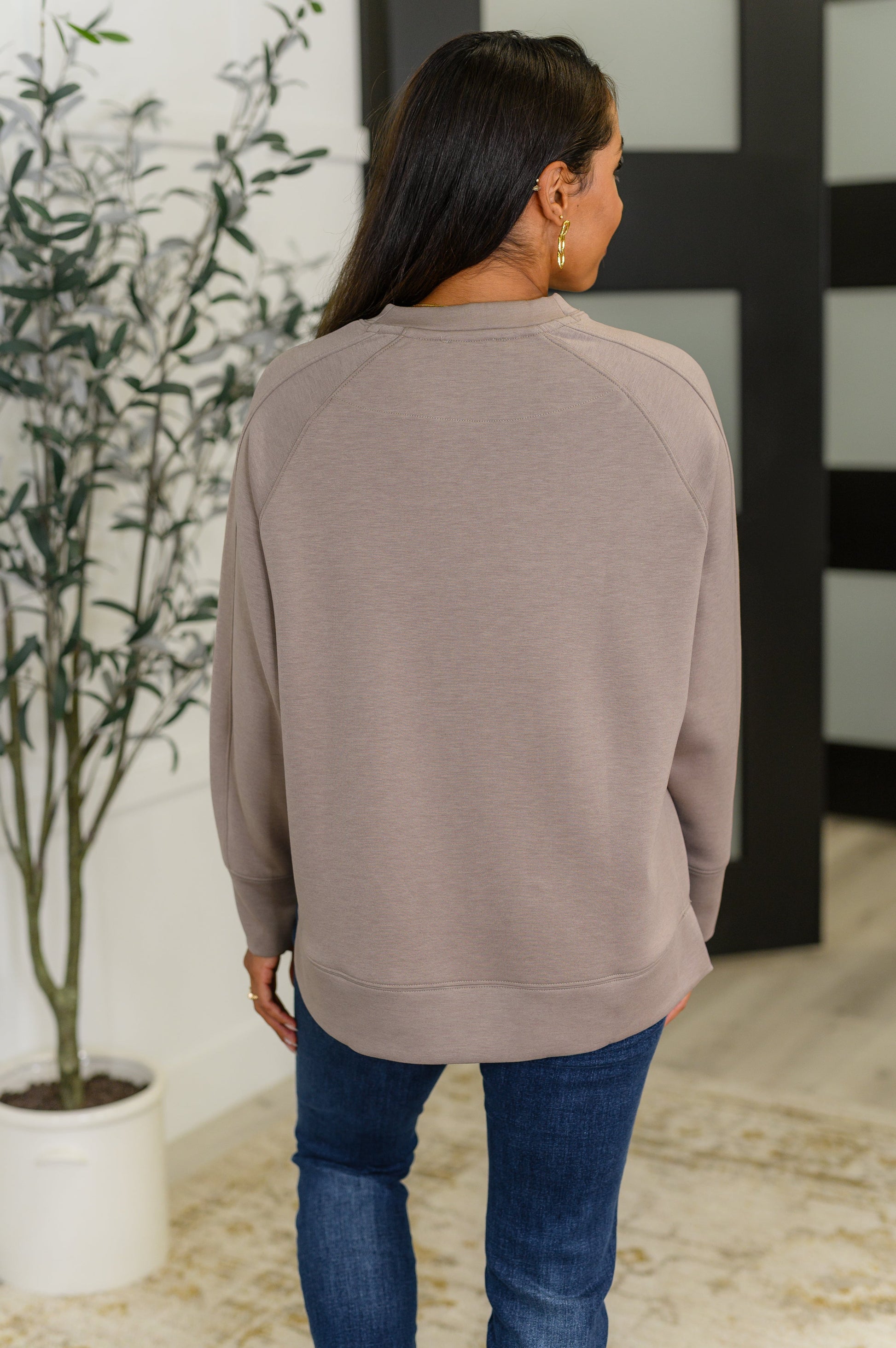 Cocoa relaxed scuba pullover with a round neckline, raglan sleeves, and side slits.
