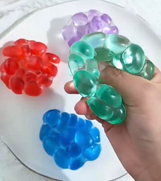 Colorful jelly bubble squishy toy being squeezed for stress relief sensory play