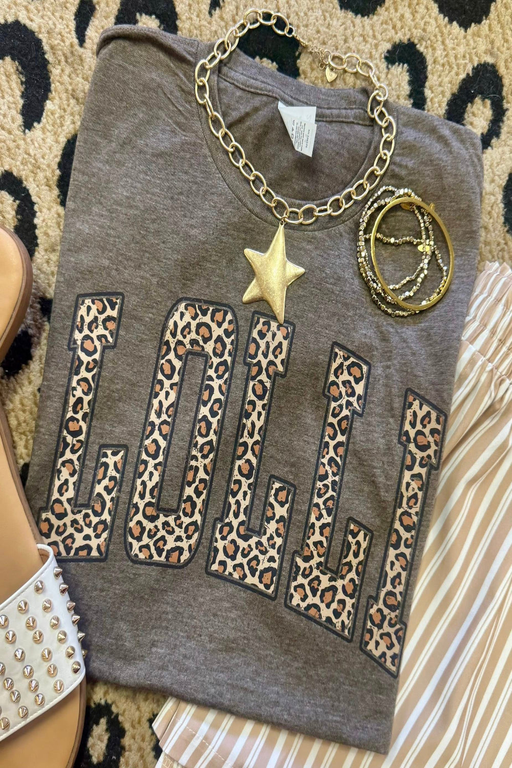 Leopard Lolli graphic tee on heather brown Tultex shirt styled with bracelets and neutral striped pants for a trendy Mother’s Day outfit.