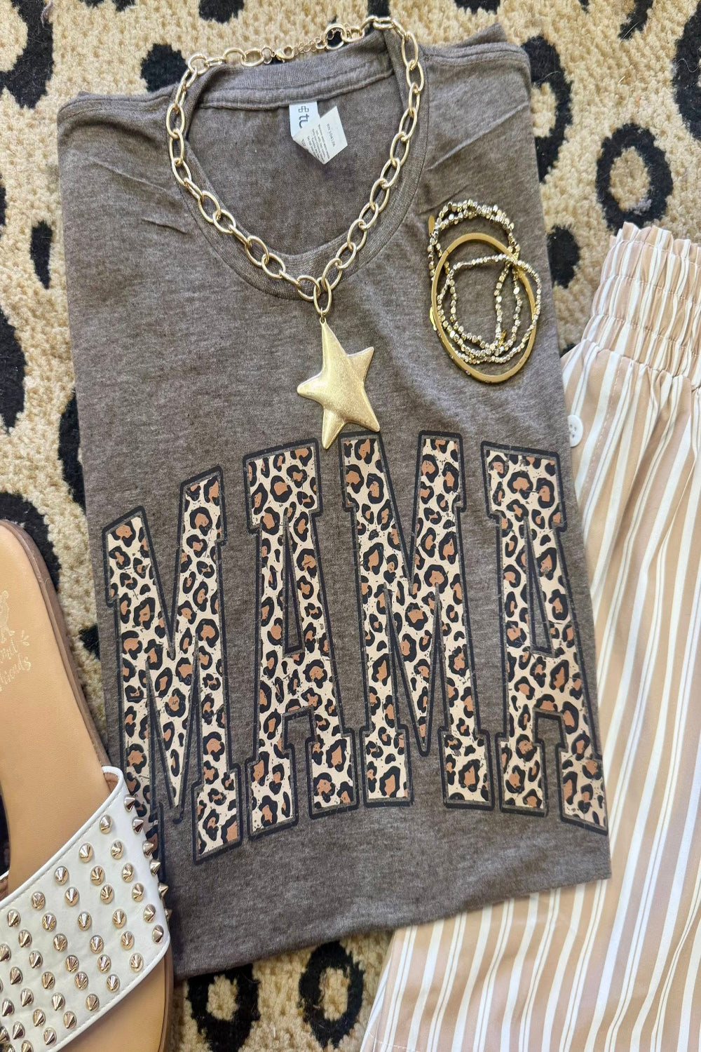 Leopard Mama graphic tee on heather brown Tultex shirt styled with bracelets and neutral striped pants for a trendy Mother’s Day outfit.