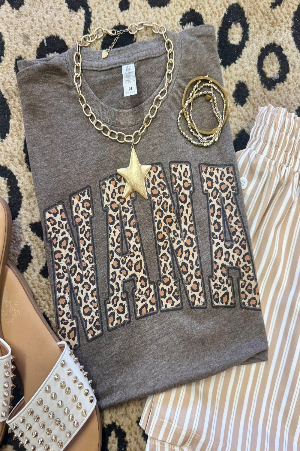 Leopard Nana graphic tee on heather brown Tultex shirt styled with bracelets and neutral striped pants for a trendy Mother’s Day outfit.