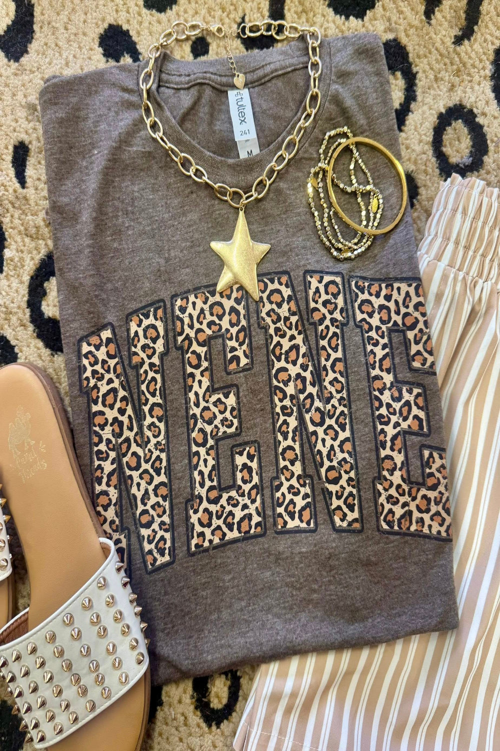 Leopard Nene graphic tee on heather brown Tultex shirt styled with bracelets and neutral striped pants for a trendy Mother’s Day outfit.