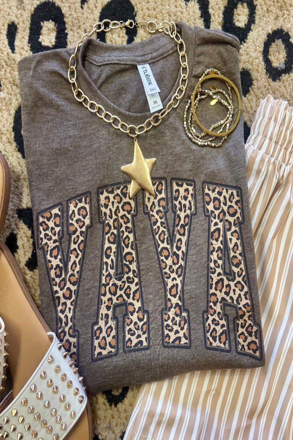Leopard Yaya graphic tee on heather brown Tultex shirt styled with bracelets and neutral striped pants for a trendy Mother’s Day outfit.