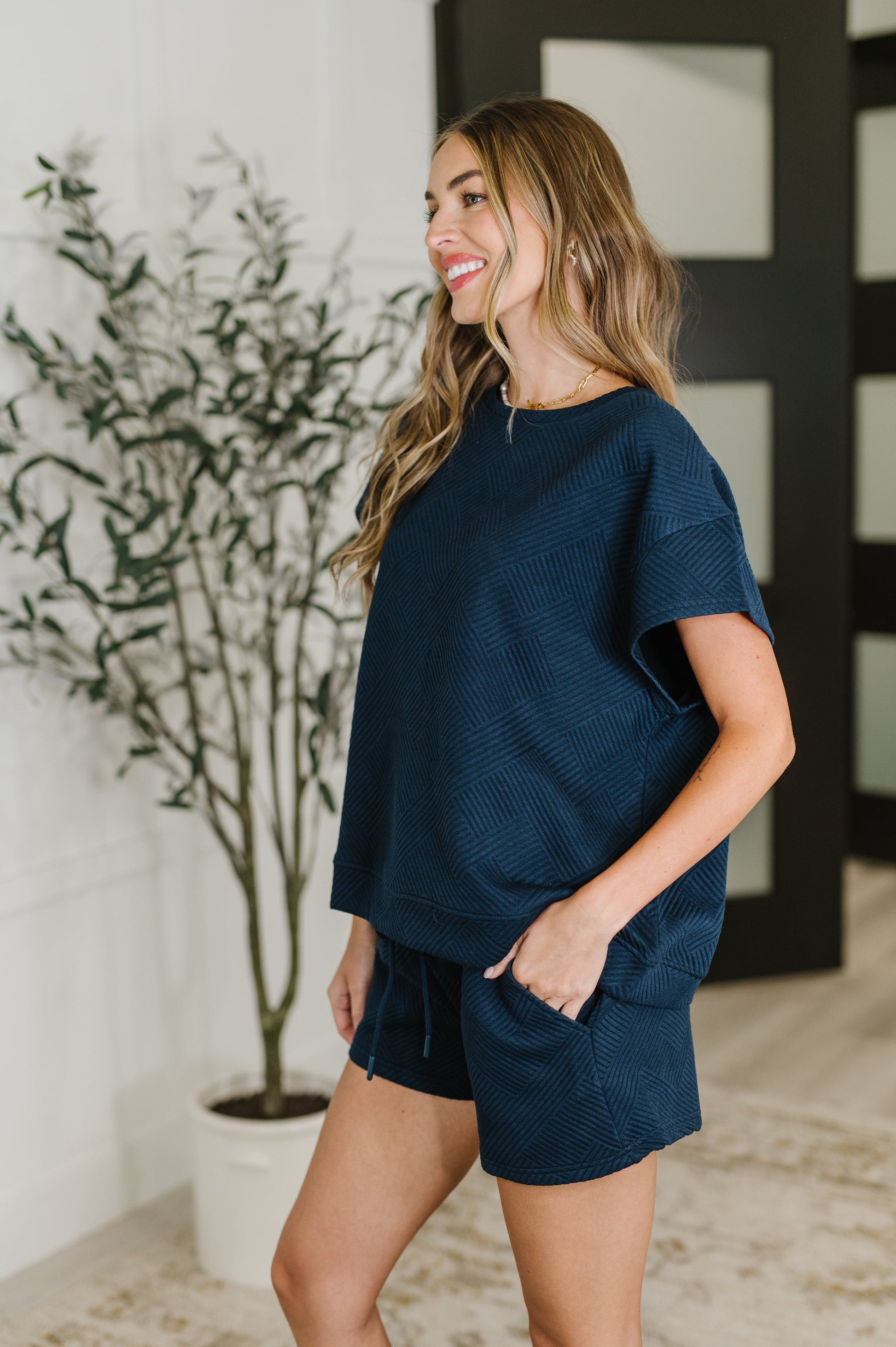 Navy Blue quilted short sleeve top by See And Be Seen. 