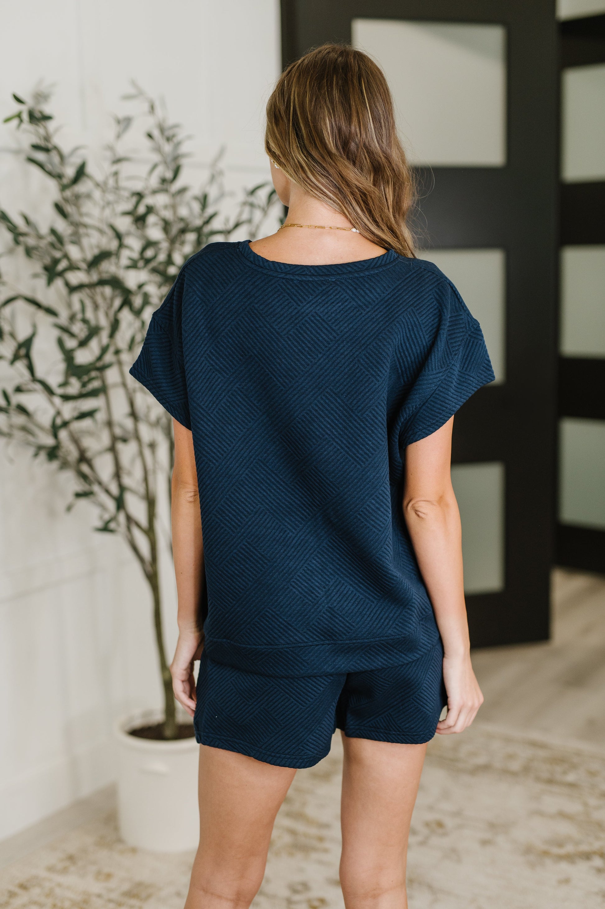Navy Blue quilted short sleeve top by See And Be Seen. 