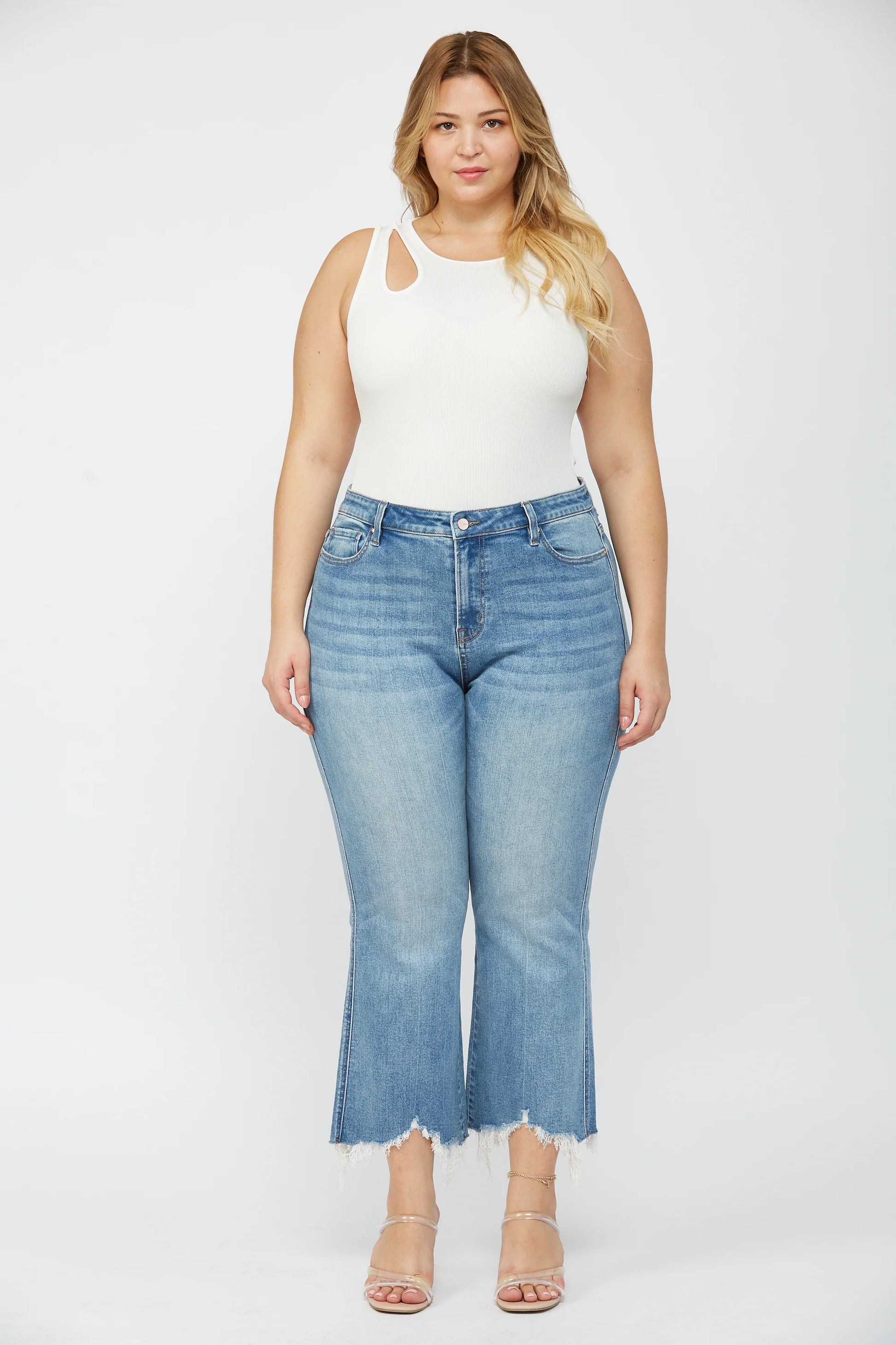 Woman wearing MICA high rise crop flare jeans with uneven raw hem and stretch denim