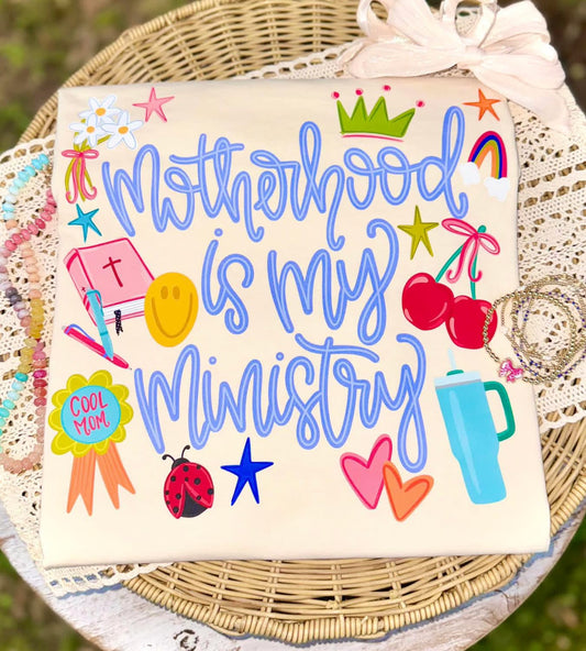 Motherhood is My Ministry graphic t-shirt with colorful icons and faith-inspired design