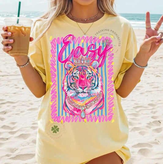 Neon Easy Tiger oversized graphic tee on butter yellow shirt featuring a colorful pink tiger design with striped background