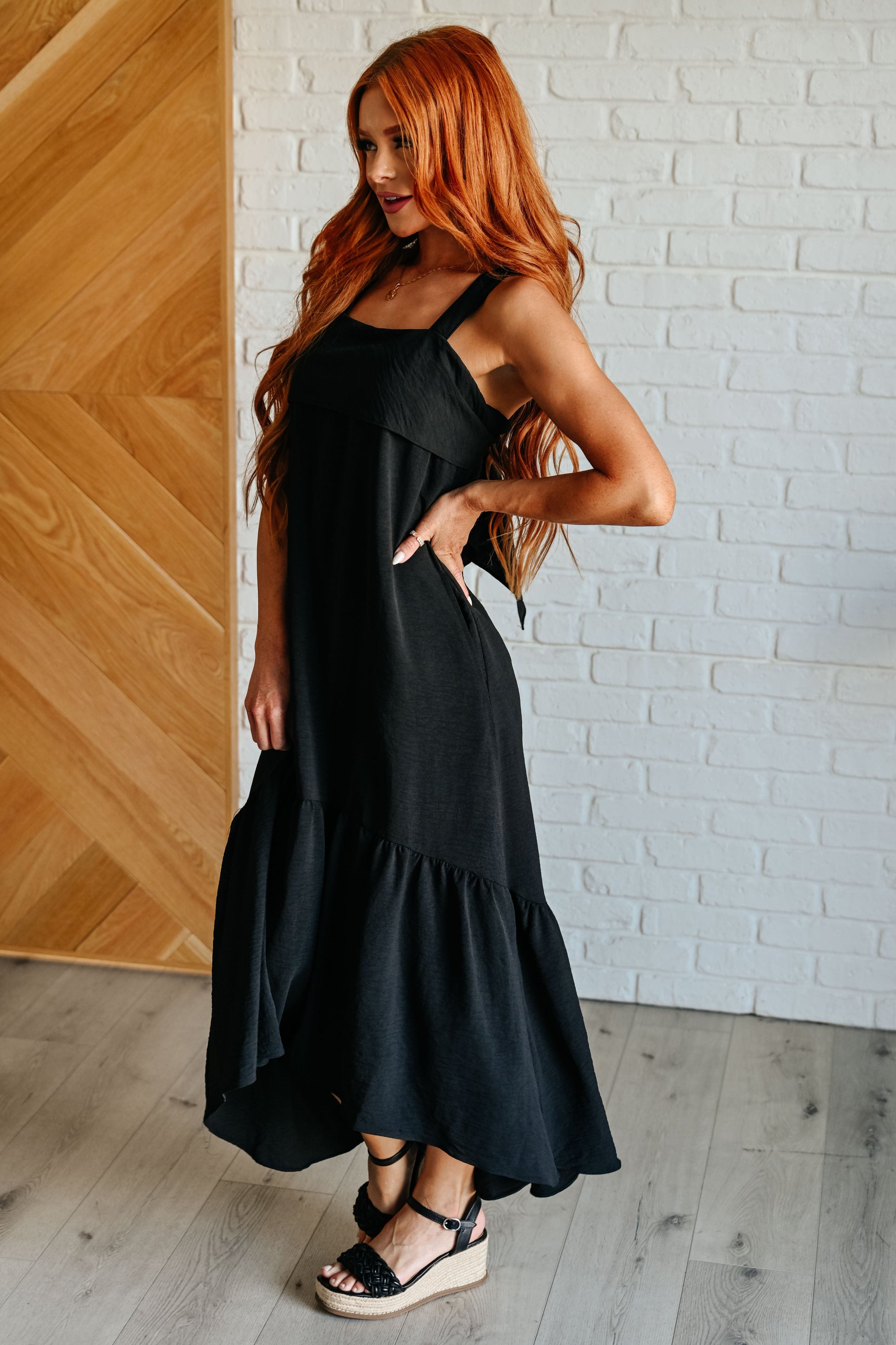 A black tie back maxi dress with a high low hem by Jodifil
Crinkle Woven
Back Tie
Bottom Ruffle
High Low Scooped Hem
Side Pockets
100% Polyester
True to Size
