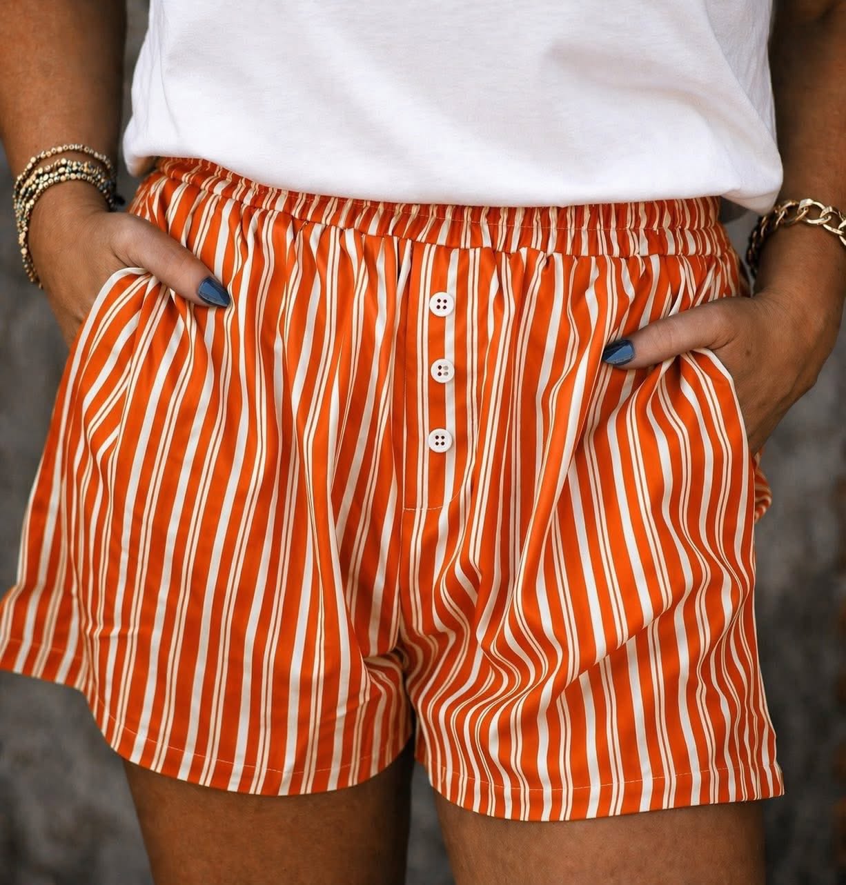 Women’s orange striped button front shorts with relaxed fit and pockets
