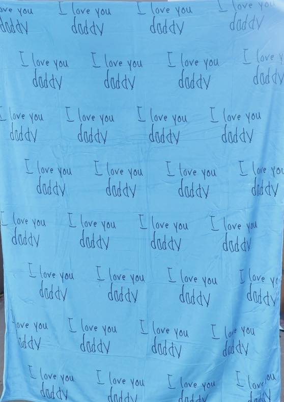 Custom handwriting blanket featuring child’s handwritten “I love you” repeated on a soft blue personalized keepsake blanket