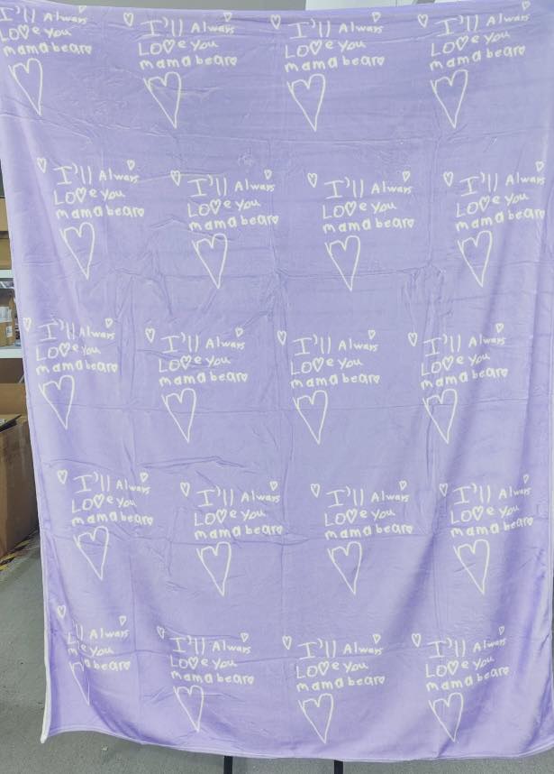 Custom handwriting blanket featuring child’s handwritten “I love you” repeated on a soft blue personalized keepsake blanket