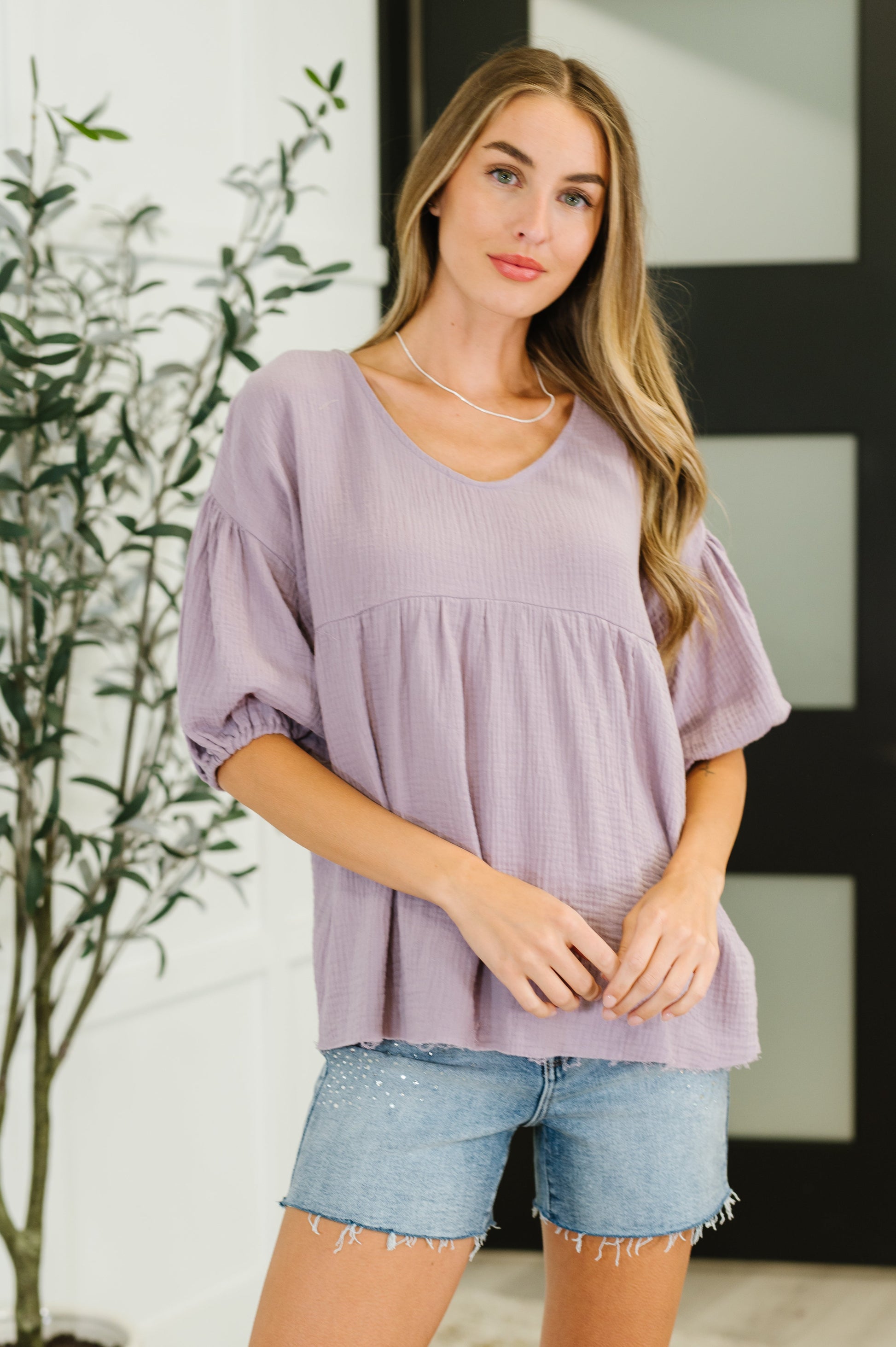 Purple peasant blouse with balloon sleeves and a V-neckline