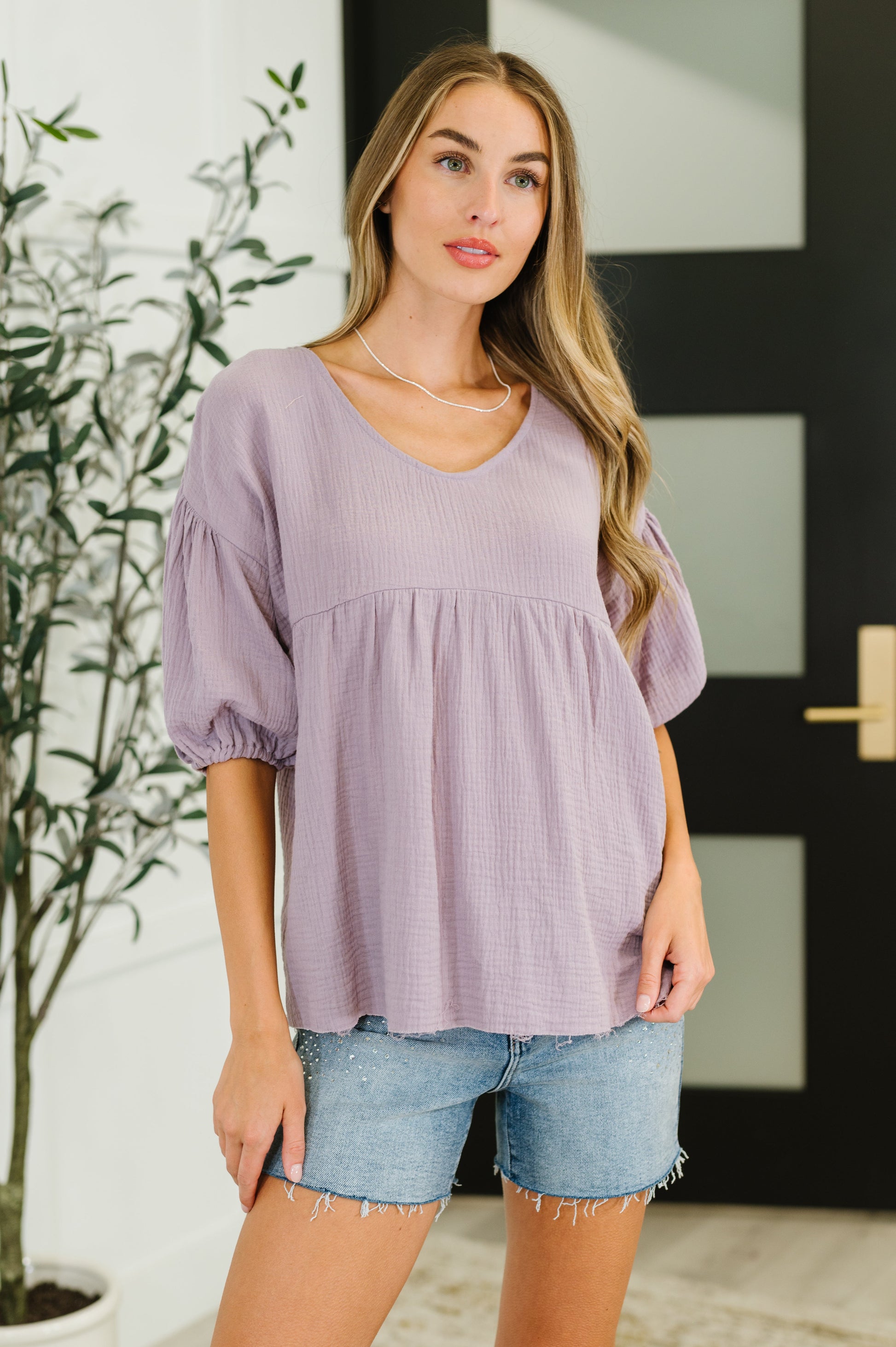 Purple peasant blouse with balloon sleeves and a V-neckline