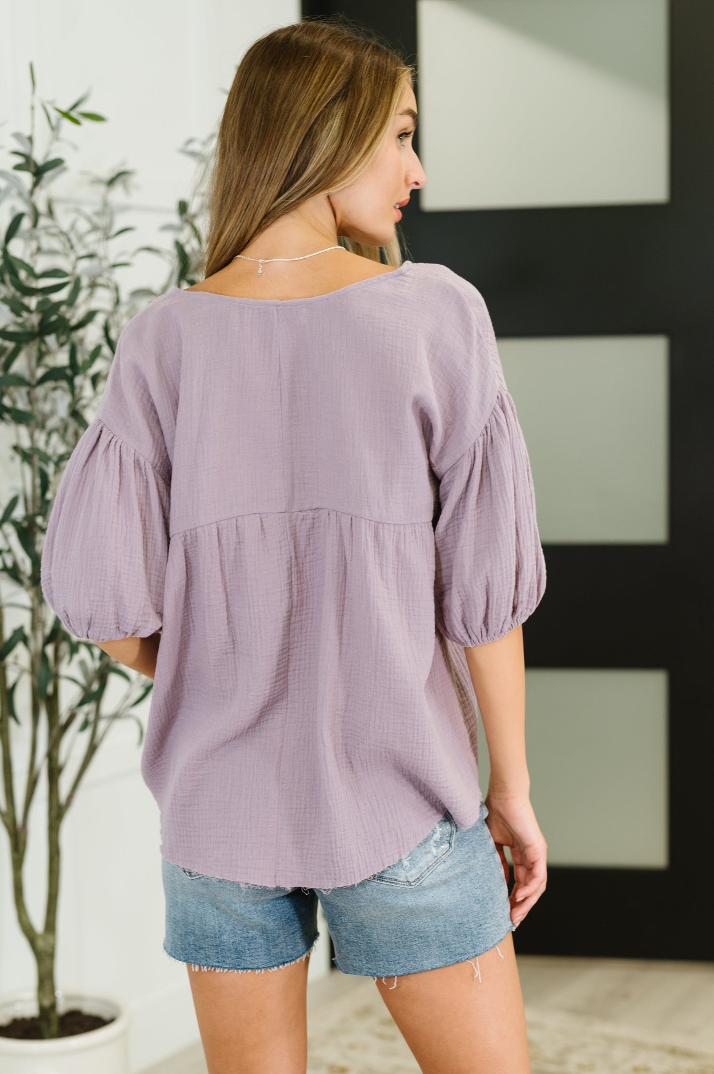 Purple peasant blouse with balloon sleeves and a V-neckline