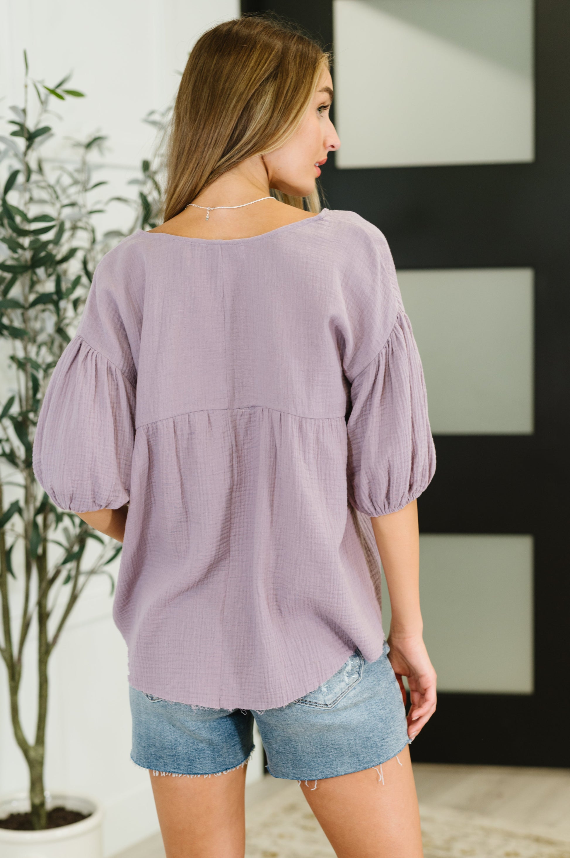 Purple peasant blouse with balloon sleeves and a V-neckline