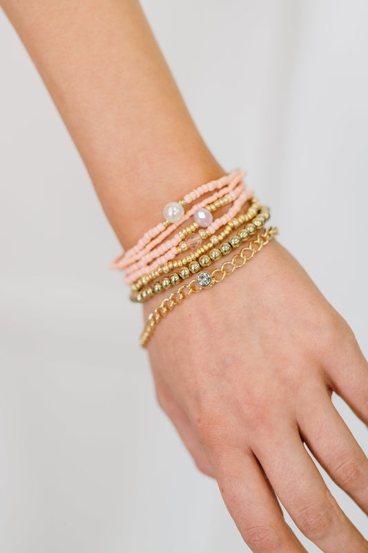 Set of 7 bracelet set in Pink and Gold
Elastic 
Beaded 
One Chain 
Pearl and Gem Details
Pink and Gold 