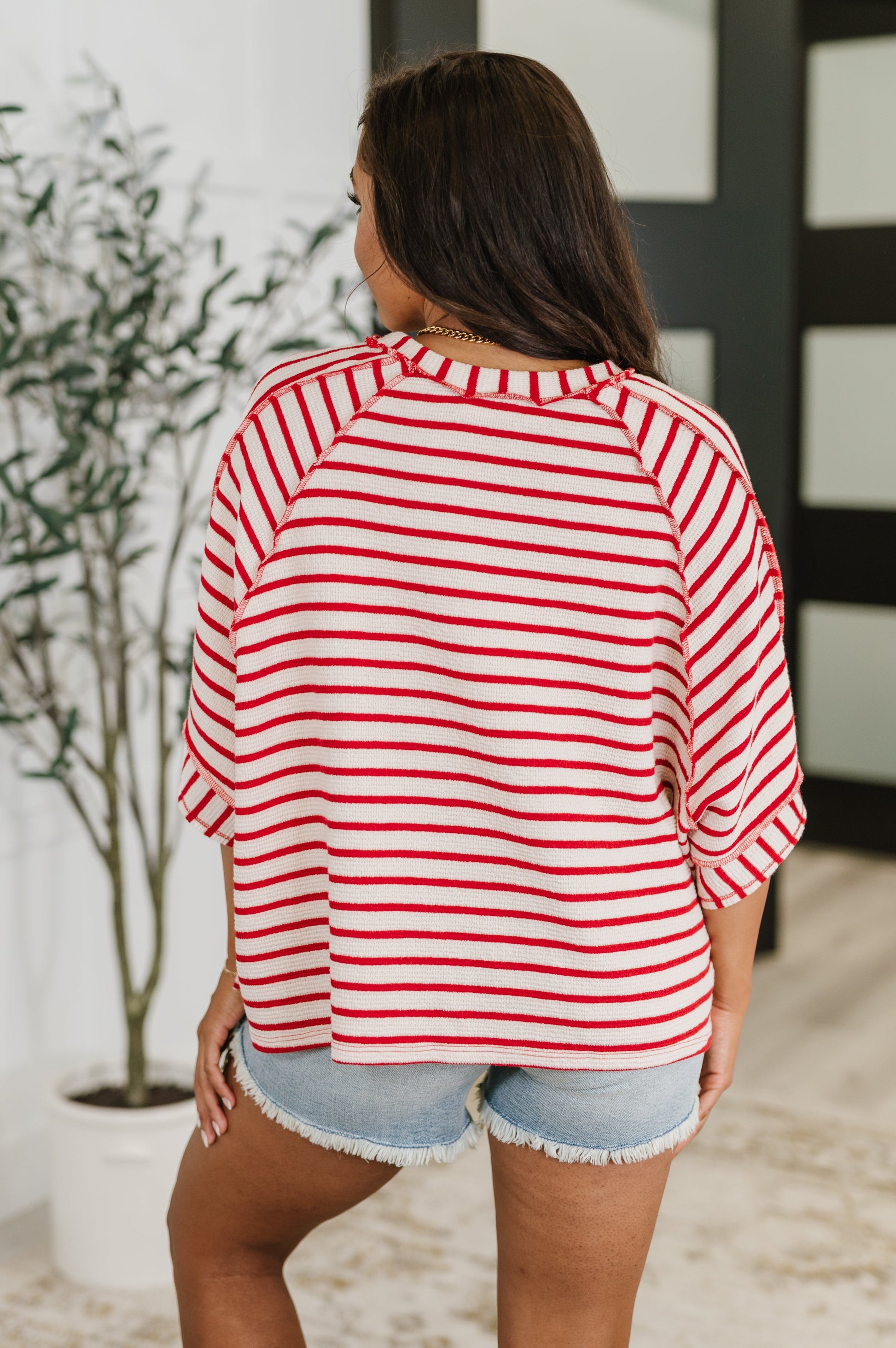  red and white striped shirt 
Textured Knit
Banded, Round Neckline
Raglan Sleeve
Exposed Seam Detail
Relaxed Fit
Small Side Slit
71% Polyester, 27% Cotton, 2% Spandex
True to Size