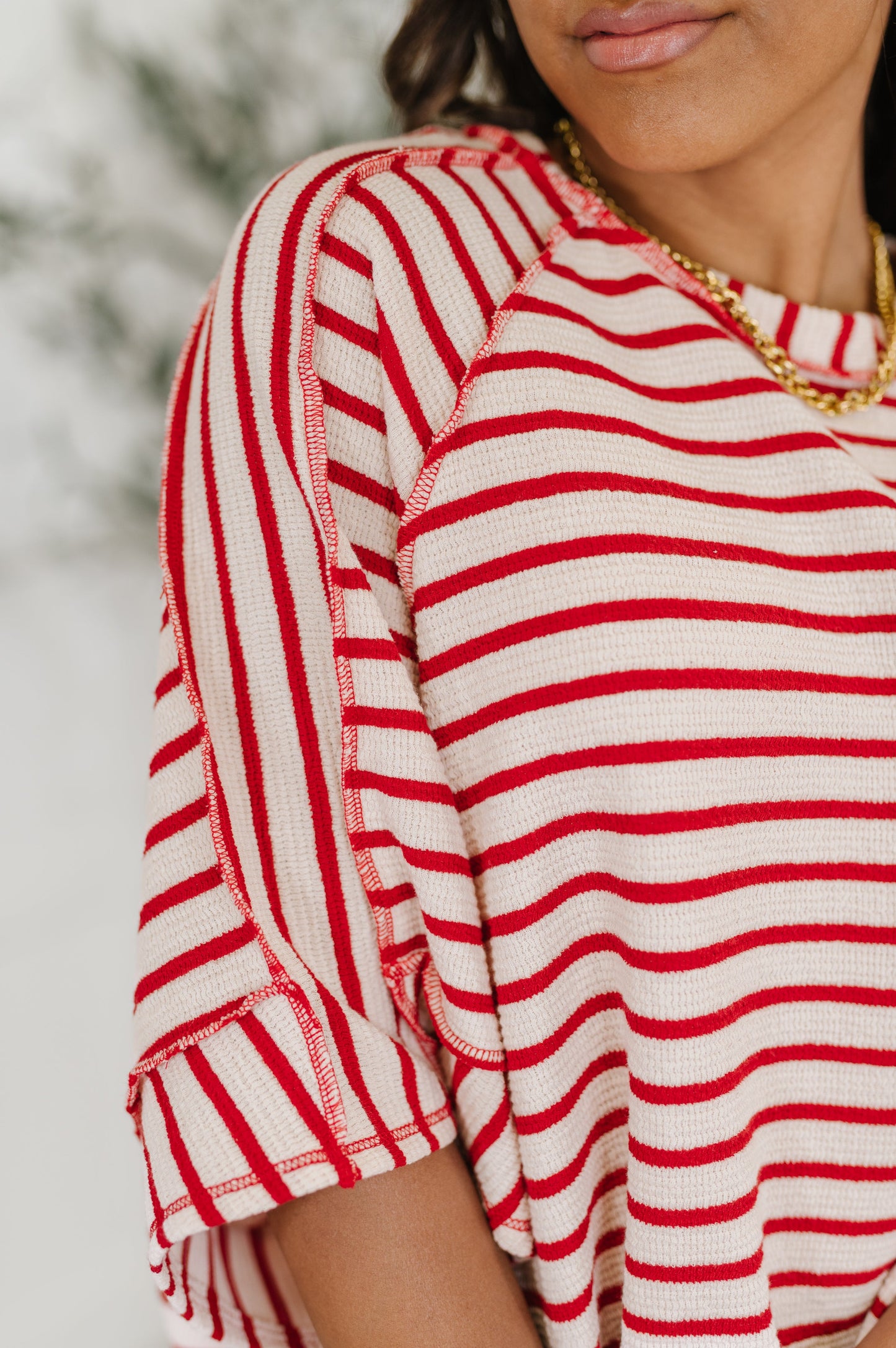 red and white striped shirt 
Textured Knit
Banded, Round Neckline
Raglan Sleeve
Exposed Seam Detail
Relaxed Fit
Small Side Slit
71% Polyester, 27% Cotton, 2% Spandex
True to Size