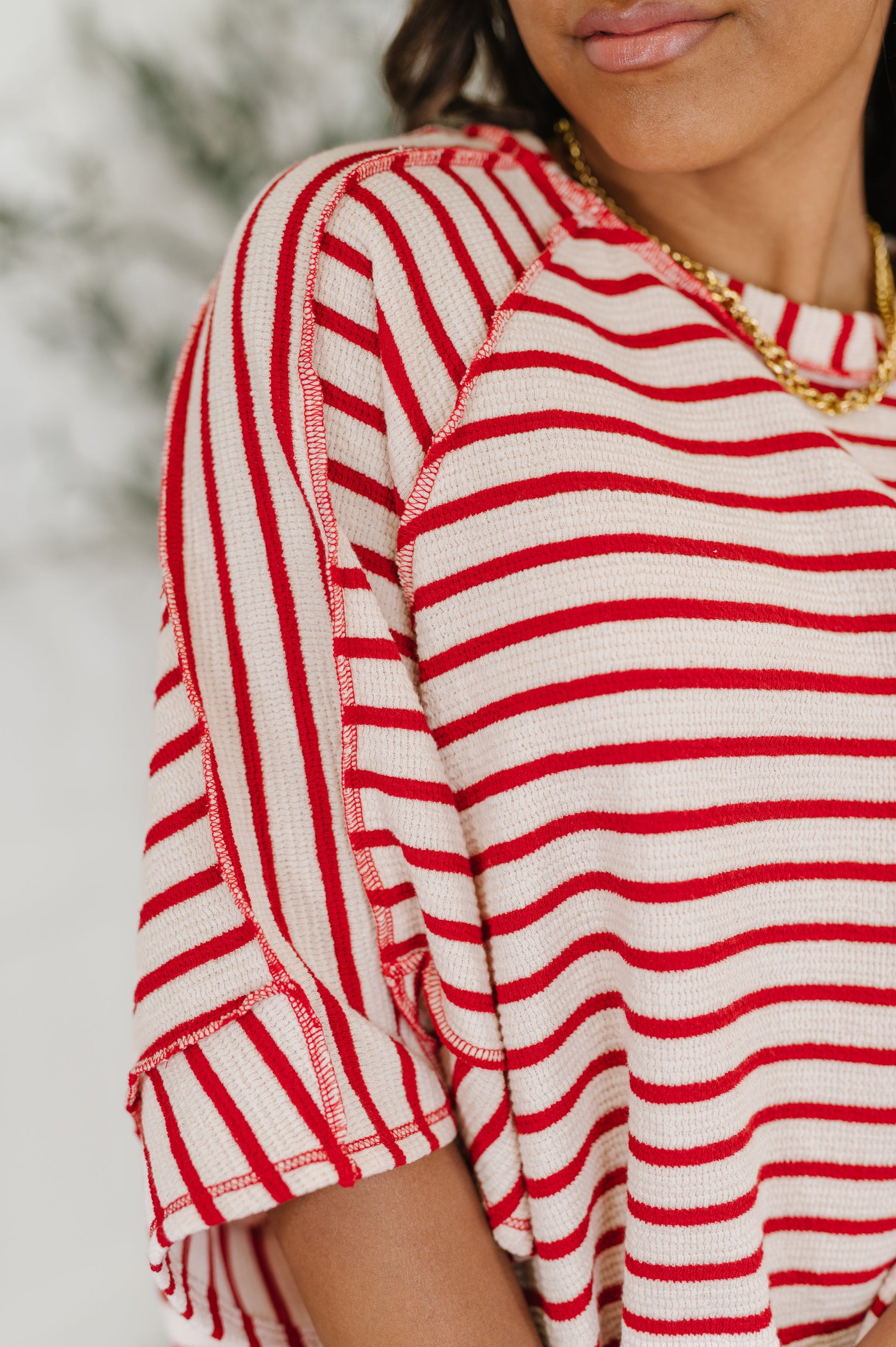  red and white striped shirt 
Textured Knit
Banded, Round Neckline
Raglan Sleeve
Exposed Seam Detail
Relaxed Fit
Small Side Slit
71% Polyester, 27% Cotton, 2% Spandex
True to Size