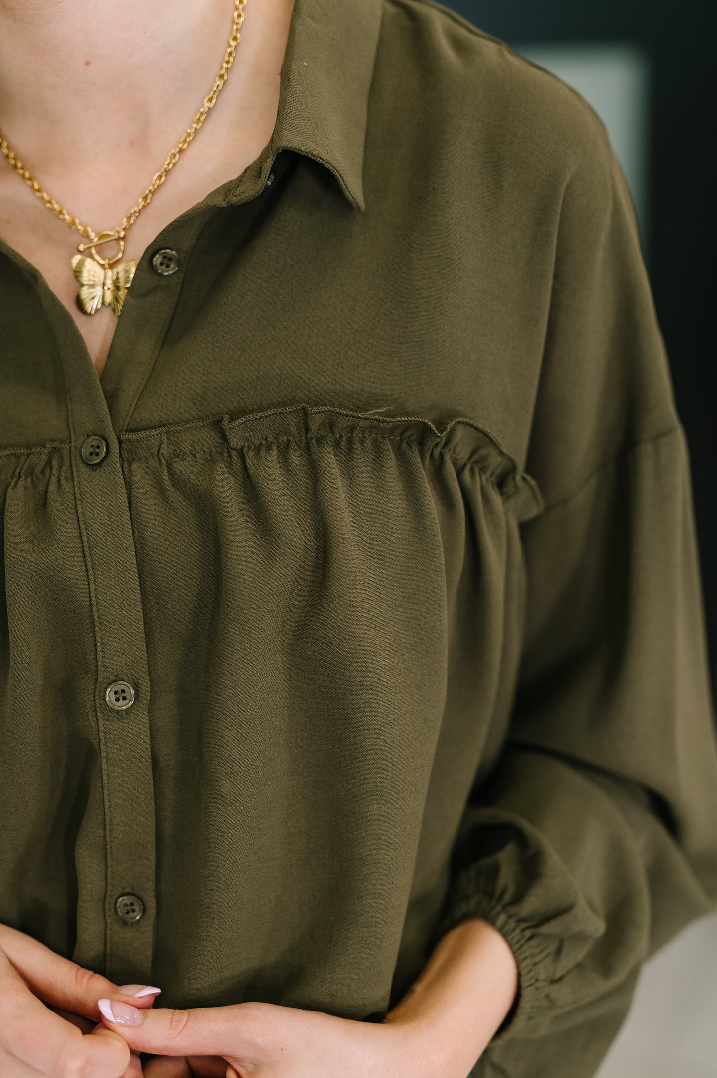 Long sleeve button down top in Olive by Andree by Unit
Woven
No-Stretch
Collared Neckline
Full Front Button Down
Cased Elastic Sleeve Cuff
Gathered, Ruffle Seam Detail
Scooped High-Low Hem
97% Polyester, 3% Spandex
True to Size