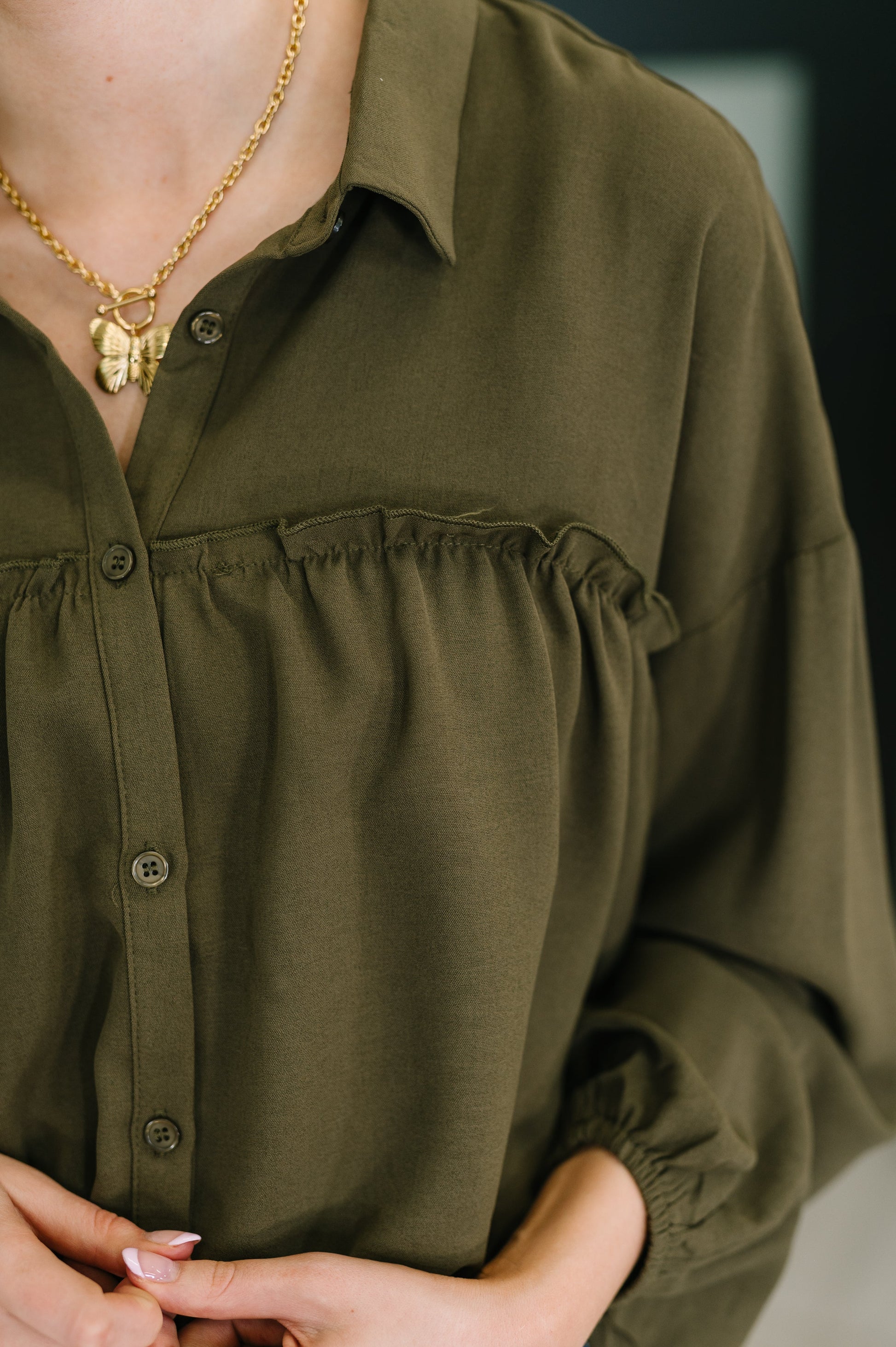 Long sleeve button down top in Olive by Andree by Unit
Woven
No-Stretch
Collared Neckline
Full Front Button Down
Cased Elastic Sleeve Cuff
Gathered, Ruffle Seam Detail
Scooped High-Low Hem
97% Polyester, 3% Spandex
True to Size