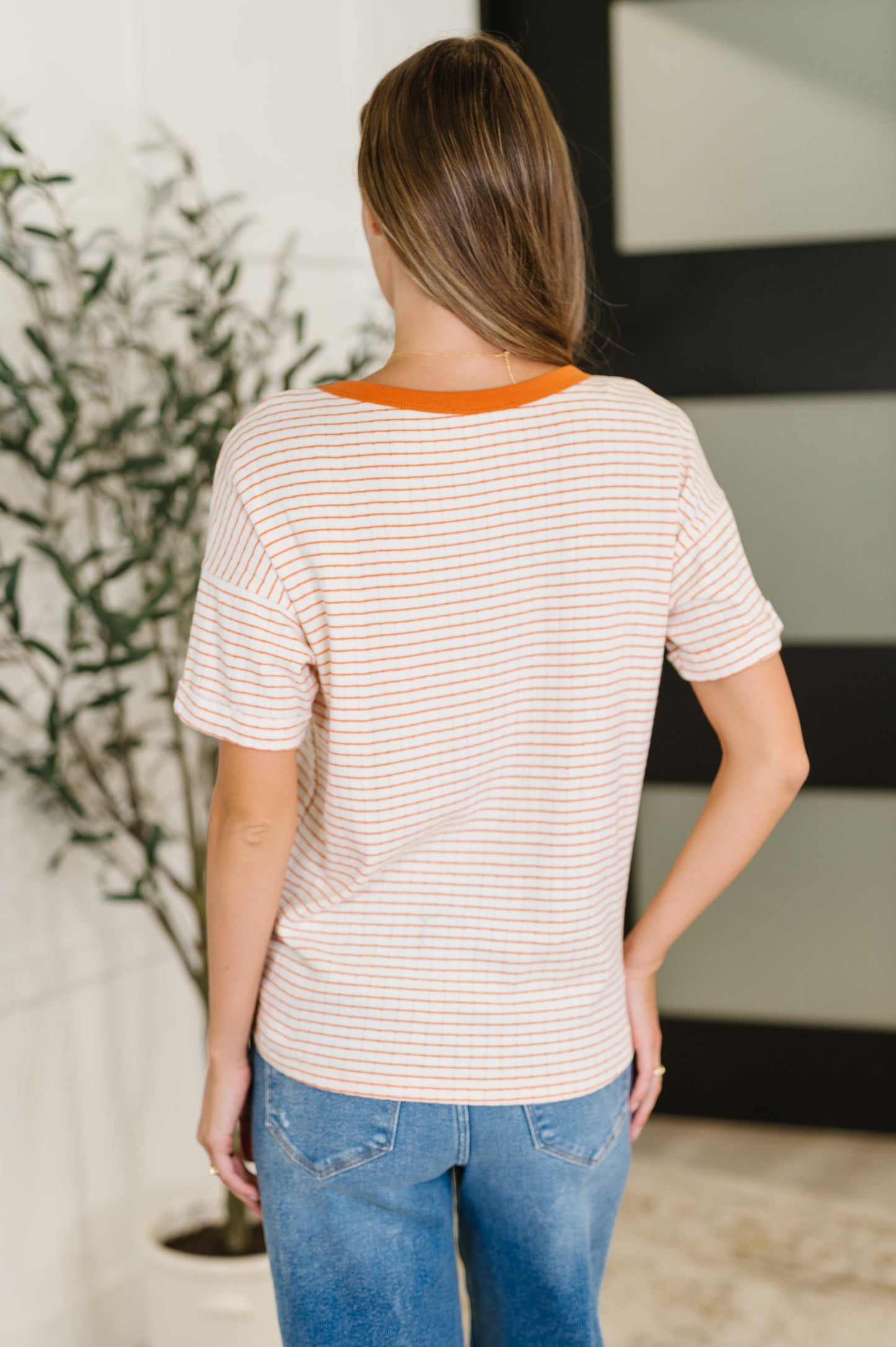 Orange stripe short sleeve top by Staccato. 
Textured Knit
Banded, Ribbed Round Neckline
Drop Shoulder
Cuffed and Tacked Sleeve Cuff
86% Cotton, 14% Polyester
True to Size