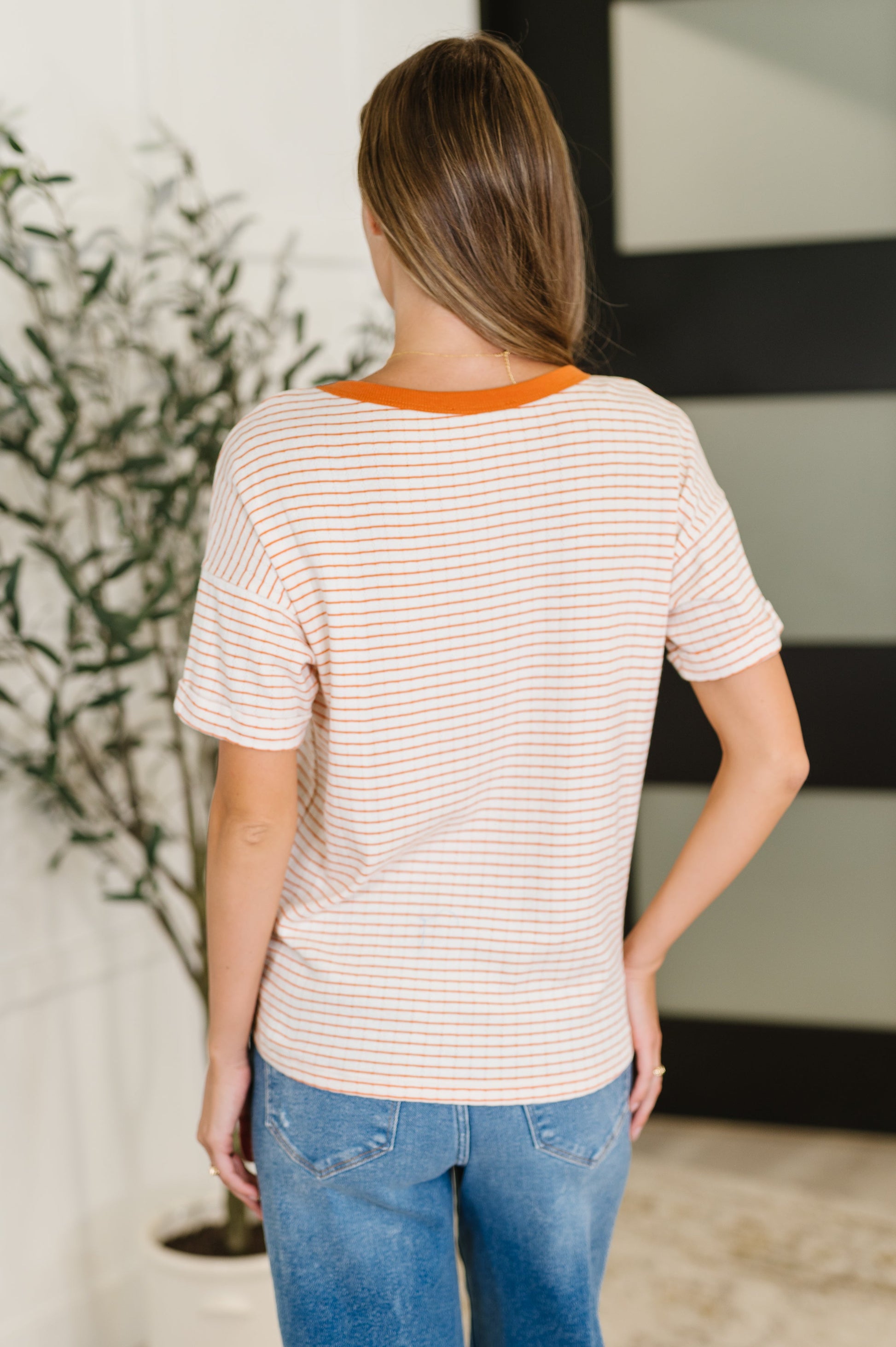 Orange stripe short sleeve top by Staccato. 
Textured Knit
Banded, Ribbed Round Neckline
Drop Shoulder
Cuffed and Tacked Sleeve Cuff
86% Cotton, 14% Polyester
True to Size