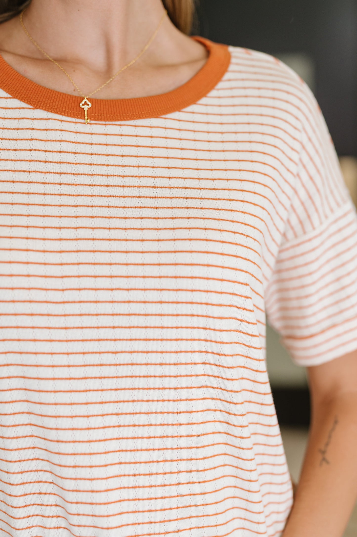 Orange stripe short sleeve top by Staccato. 
Textured Knit
Banded, Ribbed Round Neckline
Drop Shoulder
Cuffed and Tacked Sleeve Cuff
86% Cotton, 14% Polyester
True to Size