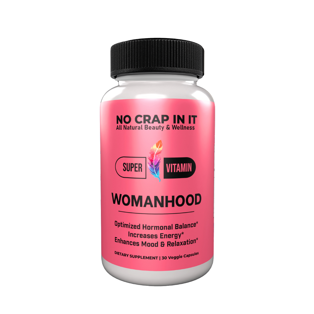 A bottle of 'No Crap In It' Womanhood Super Vitamin Supplement with pink label, black cap, and text indicating optimized hormonal balance, increased energy, and enhanced mood and relaxation.