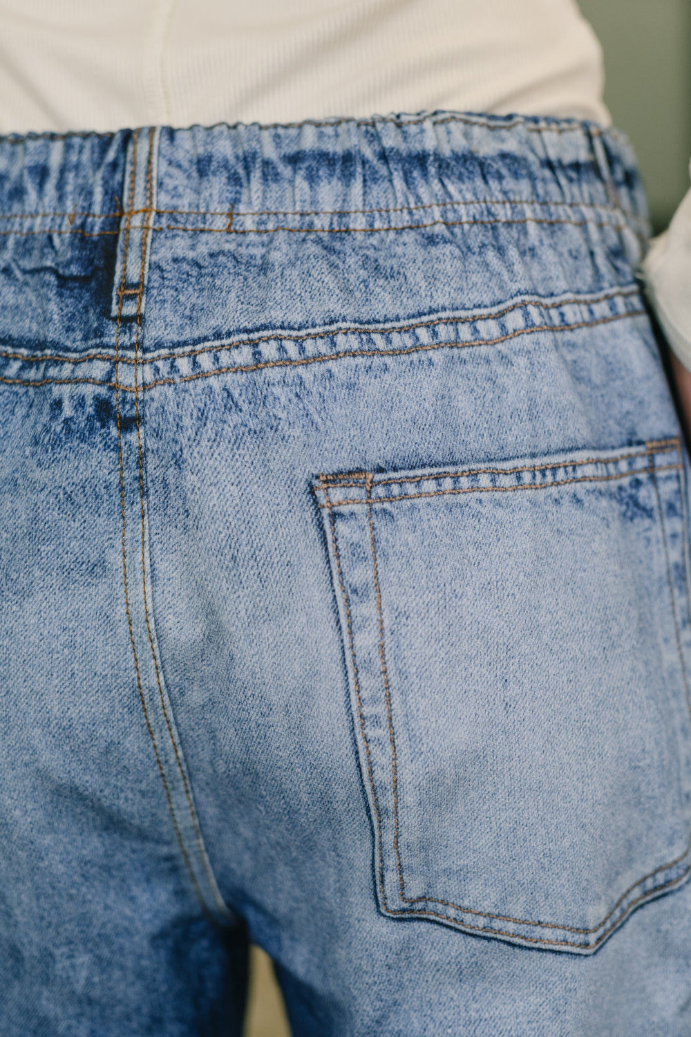 Model wearing Zenim printed wide leg pants by Dear Scarlett in stretch knit high waisted denim look with wide leg fit and side pockets