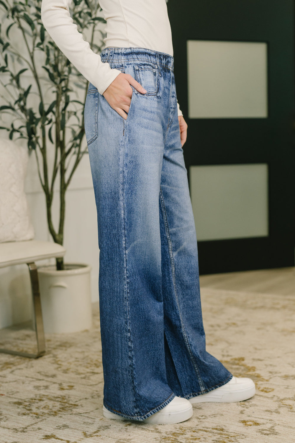 Model wearing Zenim printed wide leg pants by Dear Scarlett in stretch knit high waisted denim look with wide leg fit and side pockets