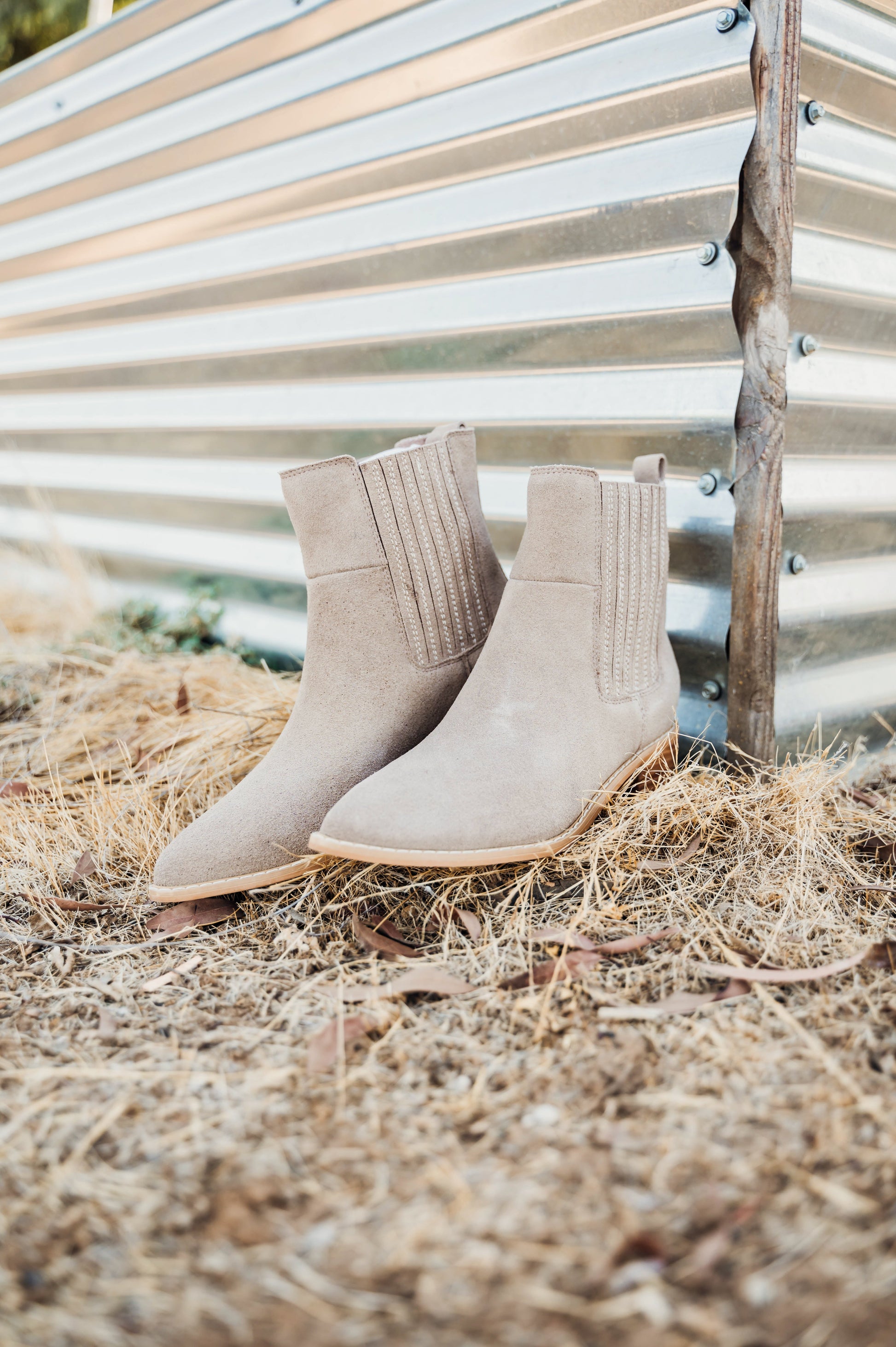 Taupe genuine suede pull on booties by Naughty Monkey. 